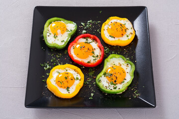 Yellow , red and green pepper with fried eggs