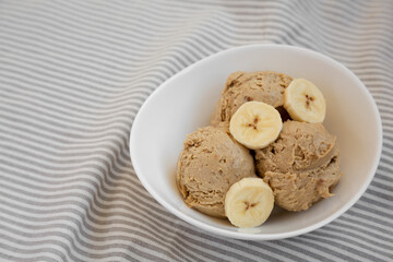Homemade Peanut Butter Banana Ice Cream in a Bowl, side view. Copy space.