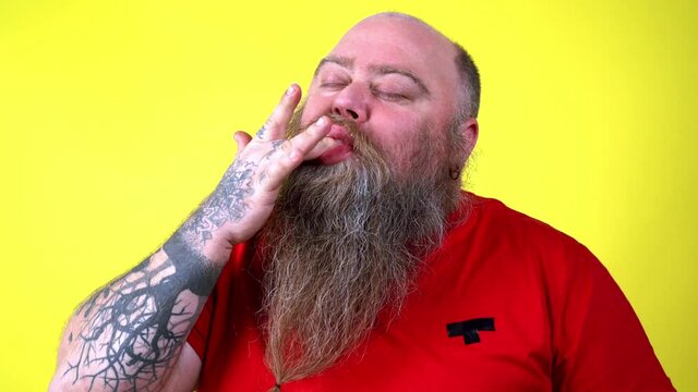 Happy chubby man eating sweets. 