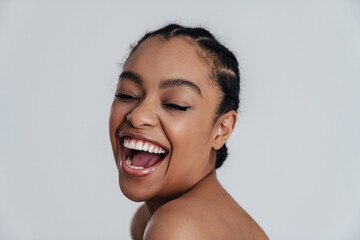 Joyful shirtless african american woman laughing at camera