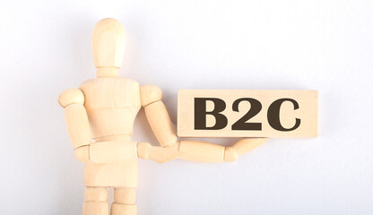 Wooden man shows with a hand to block with text B2C