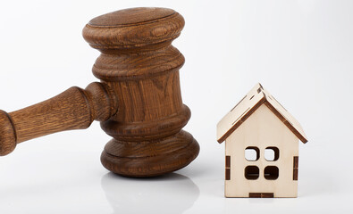 Brown gavel and model wooden house .Concept of real estate law