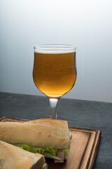 Sandwiches and beer on a wooden table, close up