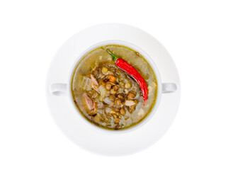 Spicy green lentil chili soup on white plate.