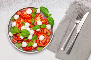 Italian caprese salad with tomatoes, mozzarella cheese and basil leaves. Top View.