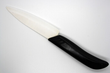 Ceramic knife with white blade and black handle.
