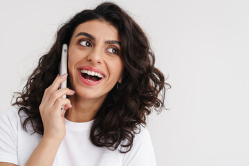 Joyful brunette girl laughing and talking on mobile phone