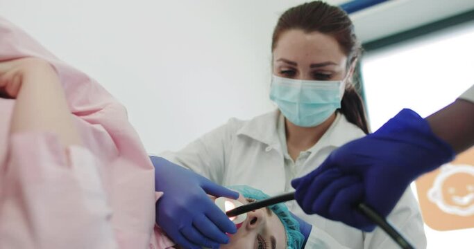 Endoscopic Operation in Hospital. African American Doctor, Medical Team Examining Colon Of Patient Who Lying On Bed, Gastroenterologist With Joystick Control Micro Camera For Colonoscopy