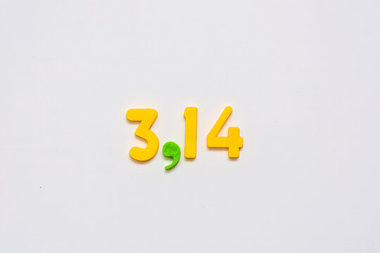 Number pi laid out by childrens numbers on a white board