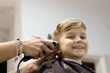 Happy boy at hairdressers.