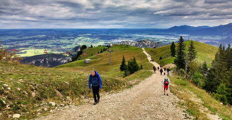 Fototapeta premium Long climb in the mountains next to a cable car. Ascent from Tannheimer Tal to Aggenstein, austria