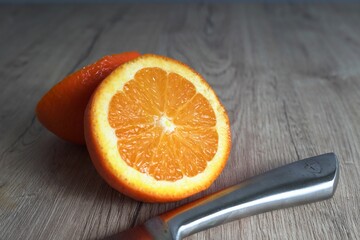 orange fruit with steel knife