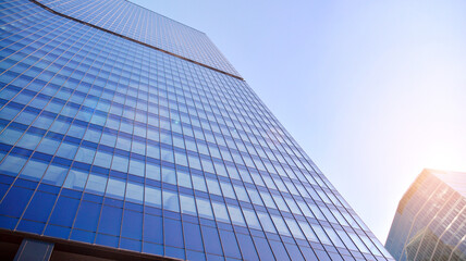 Fototapeta na wymiar Downtown corporate business district architecture. Glass reflective office buildings against blue sky and sun light. Economy, finances, business activity concept.
