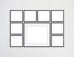 Photo frames set on white plastered textured background, nine black realistic wooden frameworks