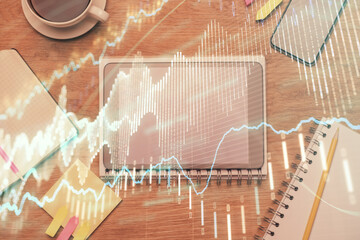 Double exposure of forex chart hologram over desktop with phone. Top view. Mobile trade platform concept.