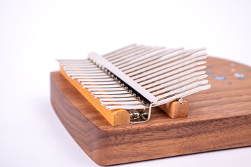 Kalimba or Mbira is an African musical instrument close up on white background. Music concept.
