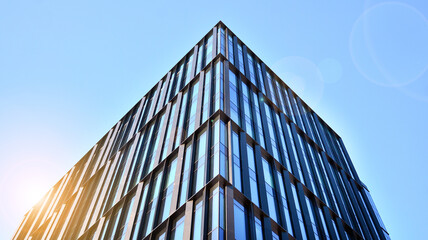 Downtown corporate business district architecture. Glass reflective office buildings against blue sky and sun light. Economy, finances, business activity concept.