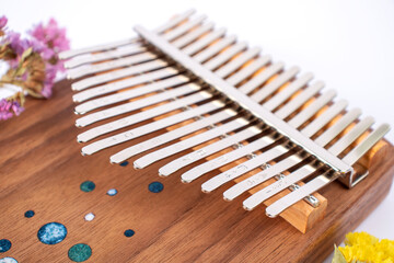 Kalimba or Mbira is an African musical instrument close up on white background. Music concept.
