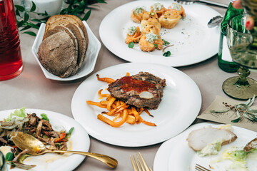 Meaty steak on a plate in a restaurant, set the table for the holiday.
