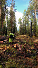 People walk along a trail in the Siberian taiga. Geologists are following the forest route.