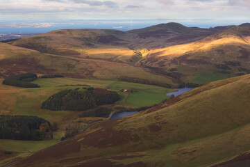 Countryside landscape view of Allermuir Hill, Glencorse Resevoir and the Firth of Forth from...