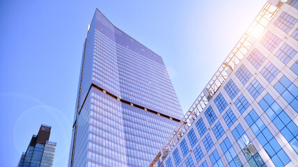 Obraz na płótnie Canvas Downtown corporate business district architecture. Glass reflective office buildings against blue sky and sun light. Economy, finances, business activity concept.