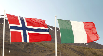 National flags - Norwegian flag and Italian flag waving in the wind side by side in Longyearbyen, Svalbard, Norway
