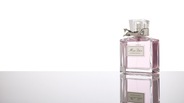 Bottle of perfume Miss Dior Blooming bouquet on white background. Christian Dior