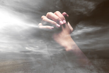 Human hands raised while praying to god