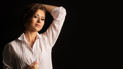 Glorious woman wears men's shirt posing  in the dark