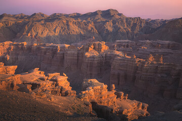 Rugged sunset or sunrise view of badlands landscape and terrain in Charyn Canyon National Park in the Almaty Province of Kazakhstan.