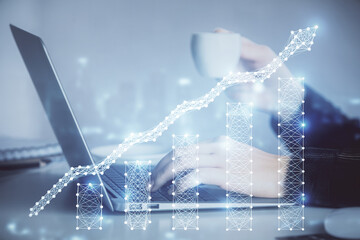 Double exposure of businesswoman hands typing on computer and forex graph hologram drawing. Financial analysis concept.