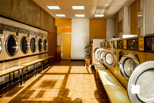 Interior of a public laundrette with washing machines and dryers 