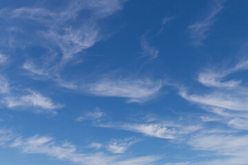 Wispy clouds on deep blue sky.