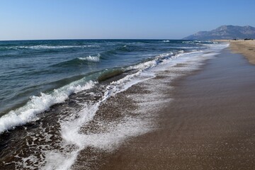 A wave on the shore of a sandy seashore. Patara Beach