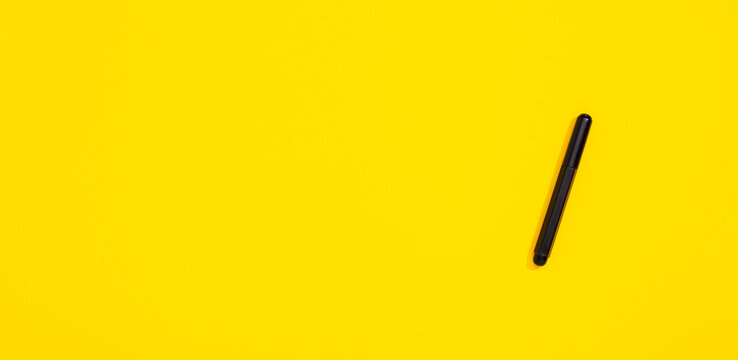 Black marker isolated on yellow background with copy space, empty text place. Closed felt-tip. Online drawing course and other distance education. Stationery store banner. Business certificate mockup - Powered by Adobe
