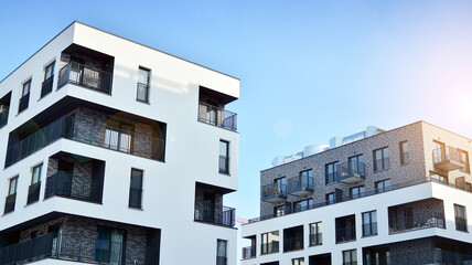 Modern apartment buildings on a sunny day with a blue sky. Facade of a modern apartment building.Glass surface with sunlight.
