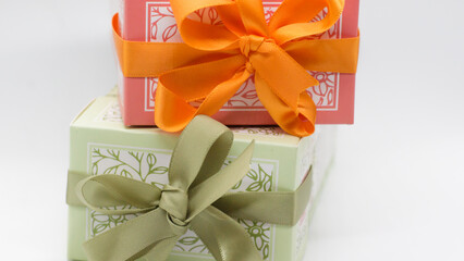 Pink gift box on the green box with bows for a celebration