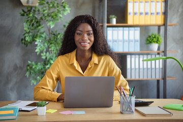 Photo of beautiful dark skin businesswoman team leader sit behind desk laptop take interview...