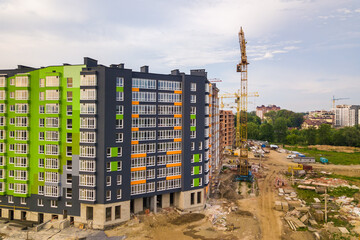 Aerial view of city residential area with high apartment buildings under construction.