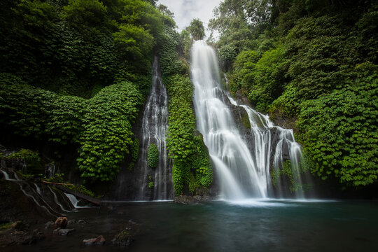 Banyumala waterfall in the north of Bali, that is in Singaraja near Lovina. Jungle waterfall cascade in tropical rainforest with rock and turquoise blue pond. its a twin waterfall in the mountain 