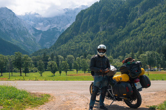 Motorcyclist man and Adventure Motorbike with bags. Motorcycle trip. World Traveling, Lifestyle Travel vacations sport outdoor concept, copy space. Zgornje Jezersko Slovenia