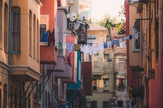 Clothes hang out to a dry amongst a colourful apartment block on Kiremit Street in the authentic and multicultural Istanbul neighbourhood of Balat.