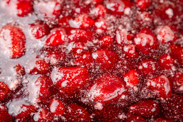 Cooking strawberry jam close up.