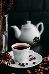 white coffee mug on black background with beans