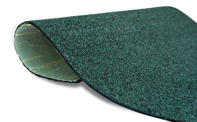 Selective focus on hunter green color shingle roof on white background. Roofing material. Shingle roof texture. Shingle roof made from asphalt, plastic fiberglass. Rough dark green granules surface.