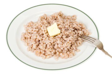 Porridge, boiled pearl barley on plate on white background