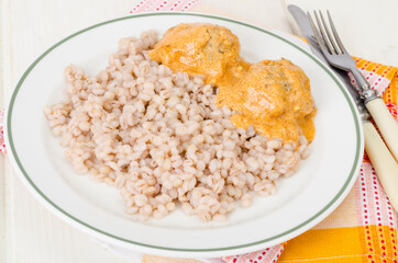 Pearl barley with meat balls. Studio Photo