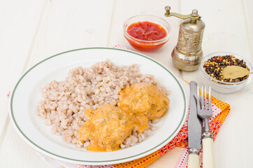 Pearl barley with meat balls. Studio Photo