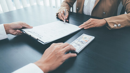 Businessman giving money while making deal to agreement financial corporate.Bribery and corruption concept